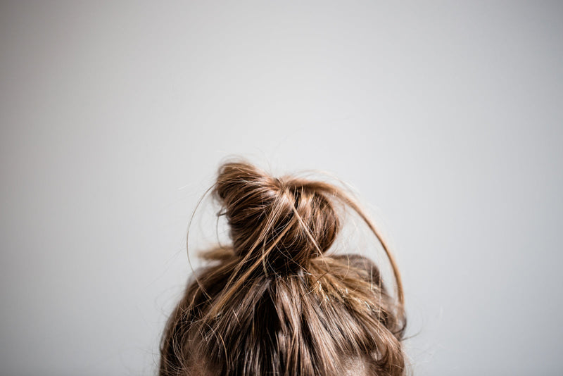 Long hair tied up in a loose bun