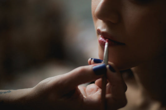 A natural lip gloss being applied to the lips