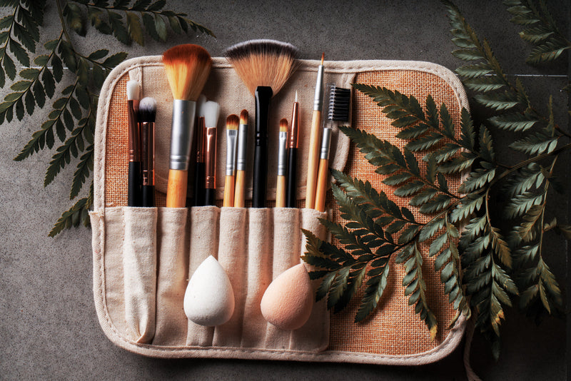 A set of makeup brushes laid out in a row