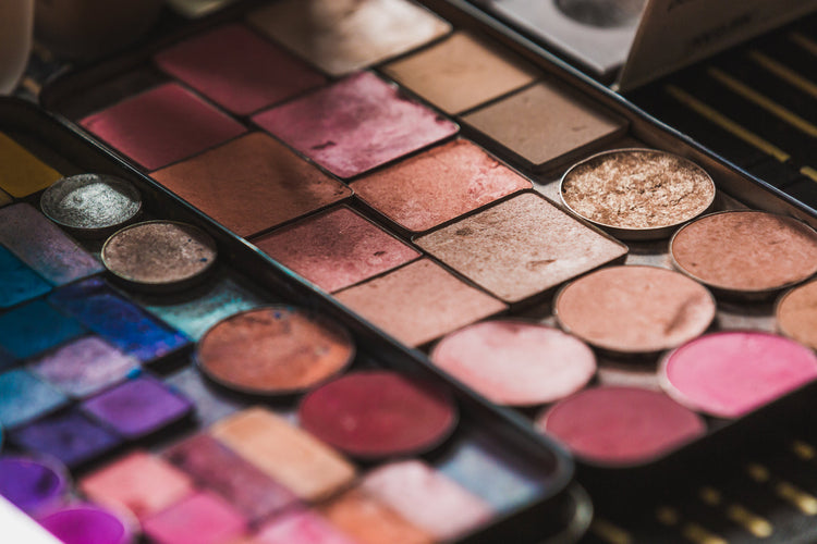 An open palette of eyeshadows and blushes