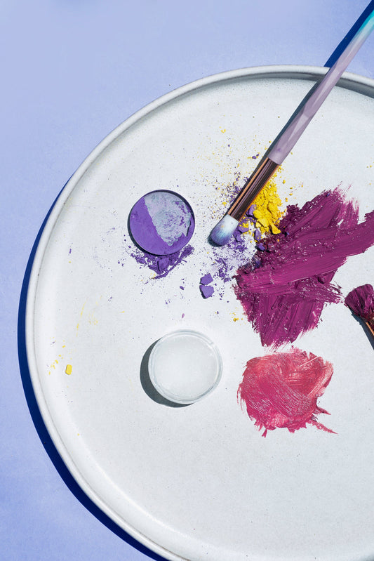 A flatlay of blush and highlighter on a round white plate