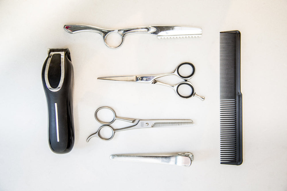 Hair scissors laid beside a straight razor