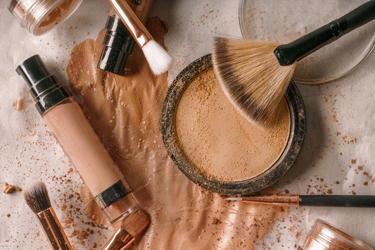 Powder, foundation and brushes arranged together