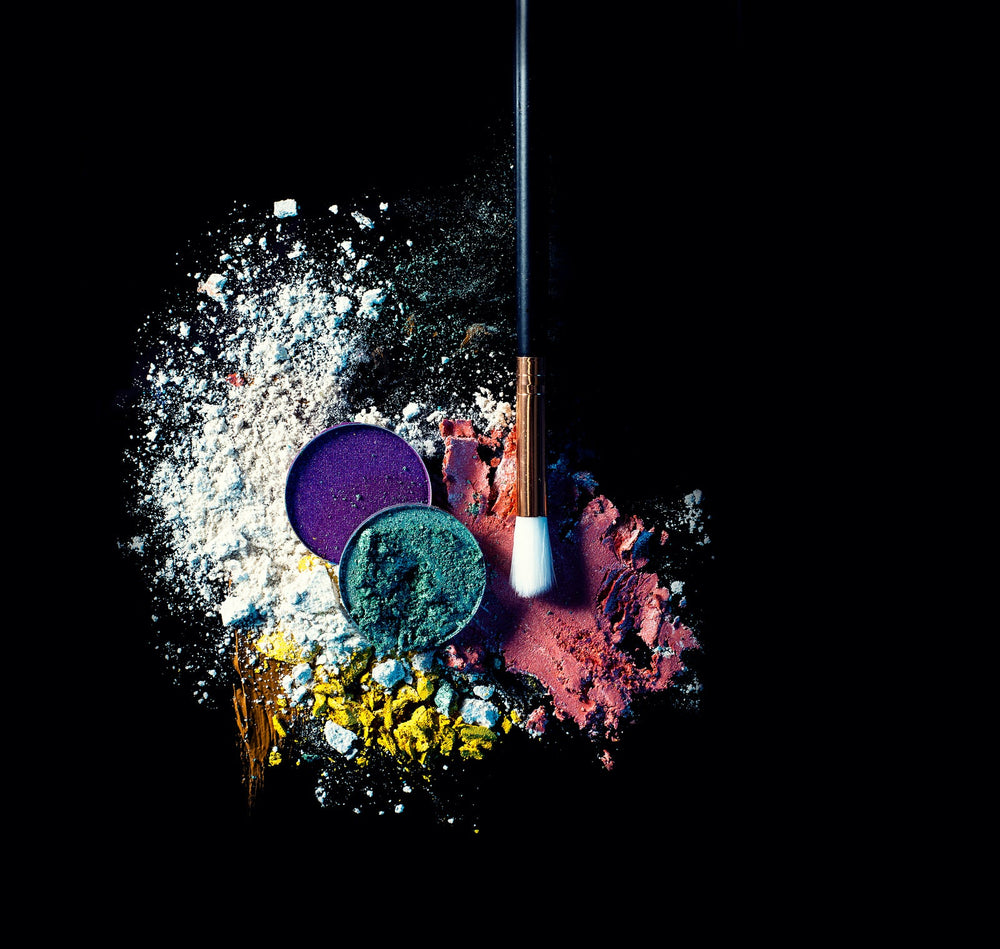 Loose makeup powder beside a powder brush