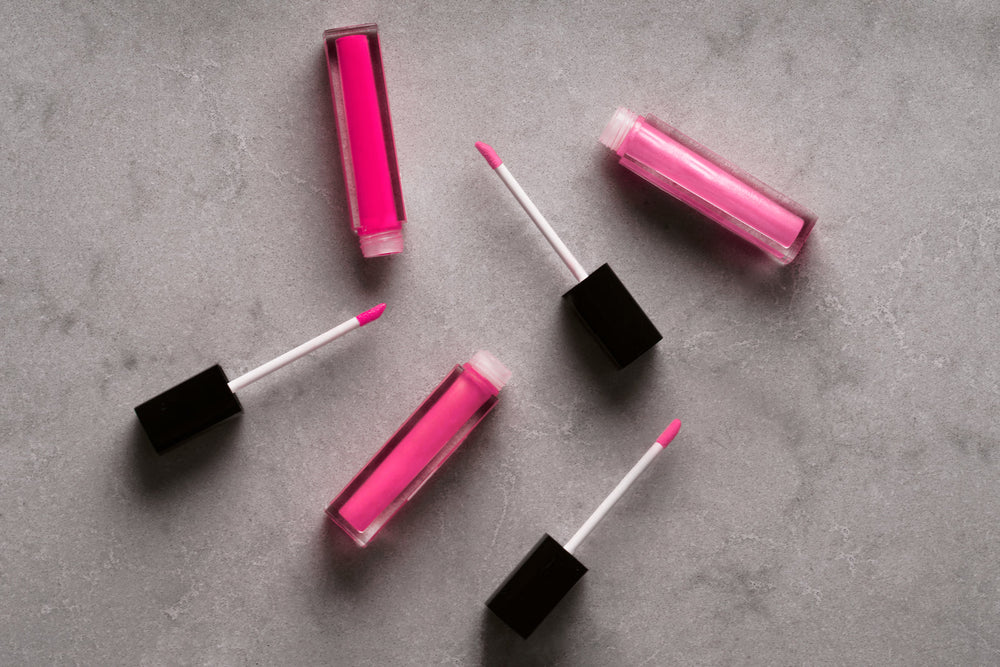 A tube of pink lip gloss with its wand