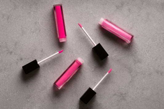 A tube of pink lip gloss with its wand